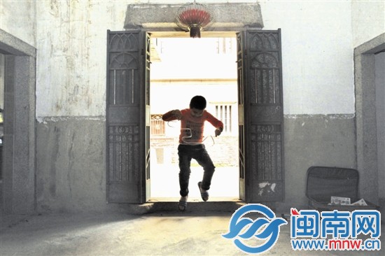 小斌一個人在房門口玩著膠帶，仿如孤獨的舞者